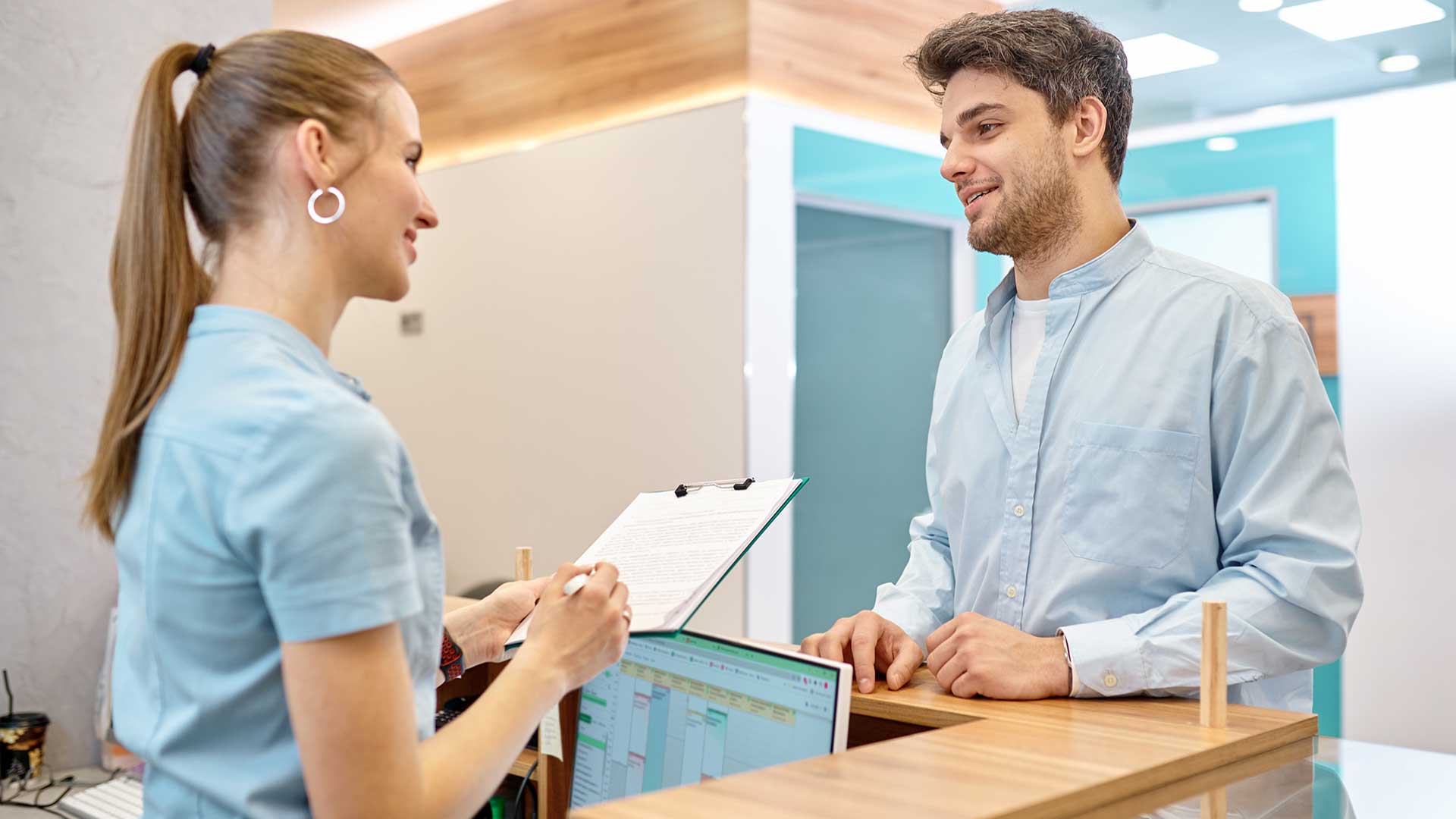 medical office administrative assistant reviews procedure disclaimer with patient