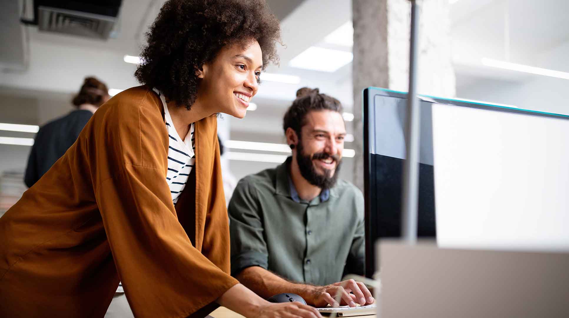 marketing professionals review digital campaign on computer