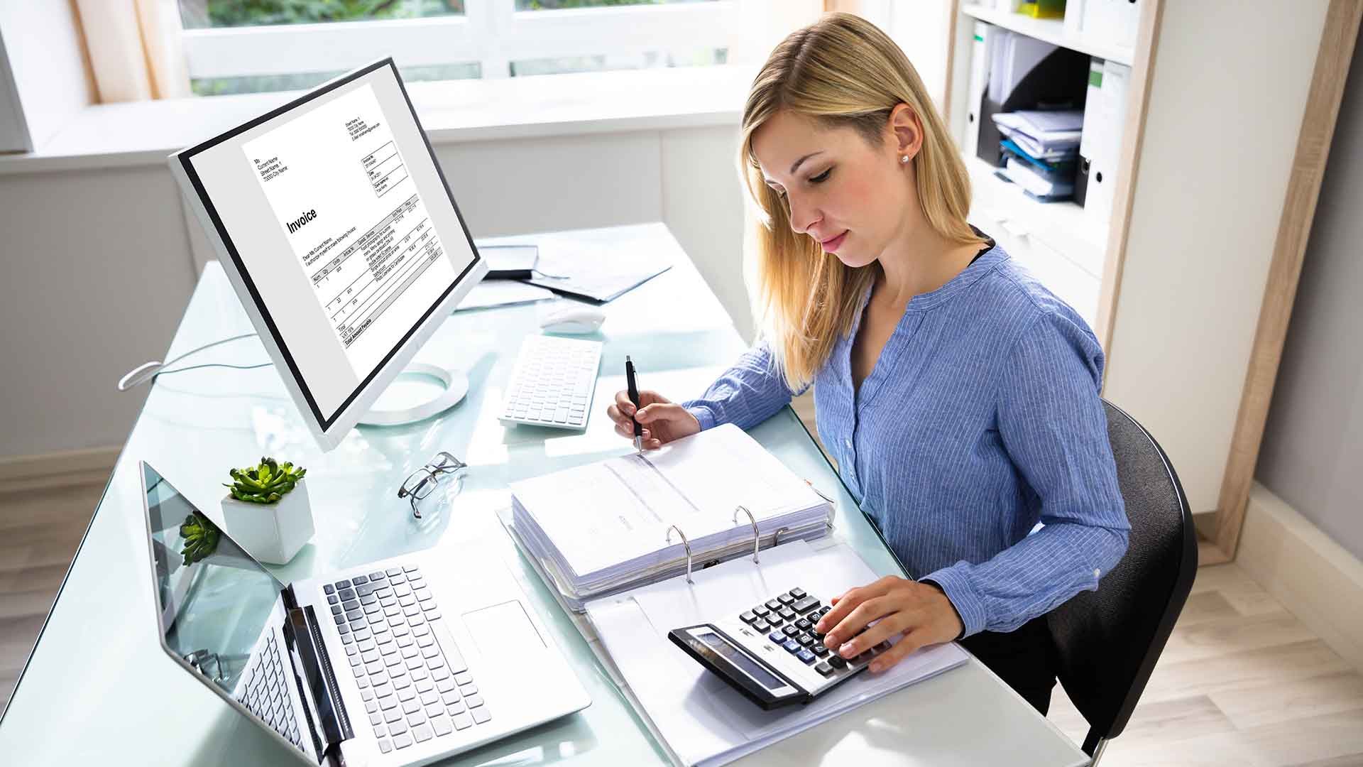 female accountant reviews client accounts and creates invoices